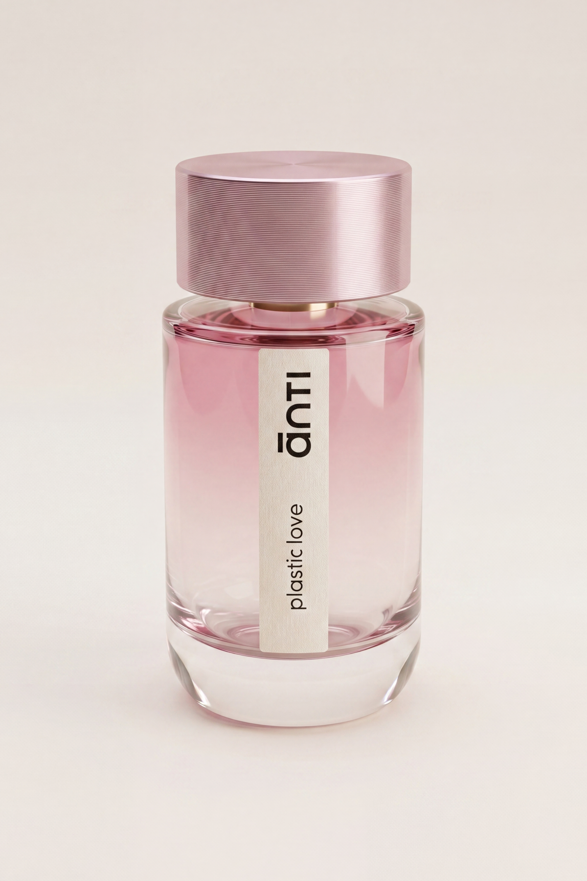 plastic love by ānti, a pink ombré 100ml fragrance bottle with a brushed pink cap on a plain off-white background